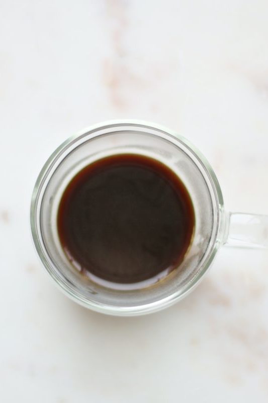 black liquid in clear glass mug